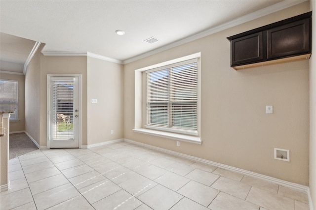 unfurnished dining area featuring light tile patterned floors, crown molding, and a healthy amount of sunlight