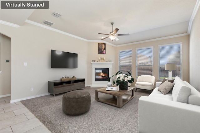 living room with crown molding, light tile patterned floors, and ceiling fan