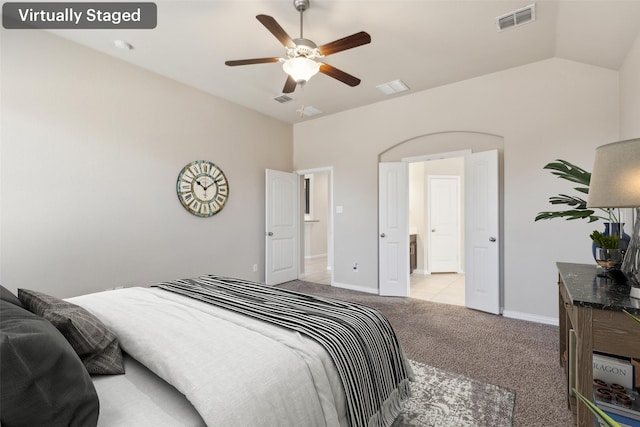 carpeted bedroom with vaulted ceiling and ceiling fan