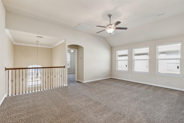 carpeted empty room with ornamental molding, lofted ceiling, and ceiling fan