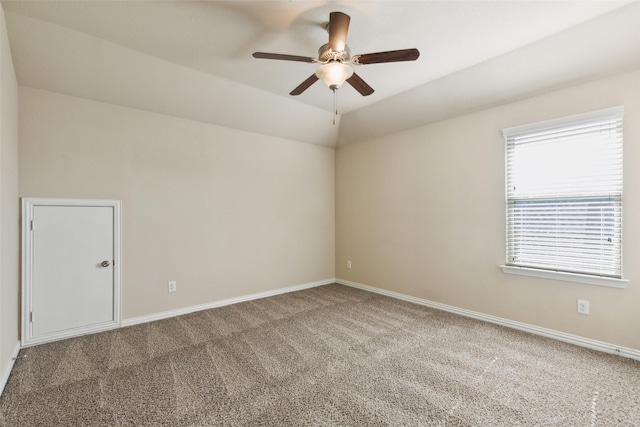 carpeted spare room with ceiling fan and vaulted ceiling