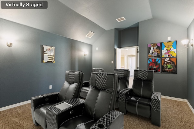 home theater room with lofted ceiling and carpet flooring