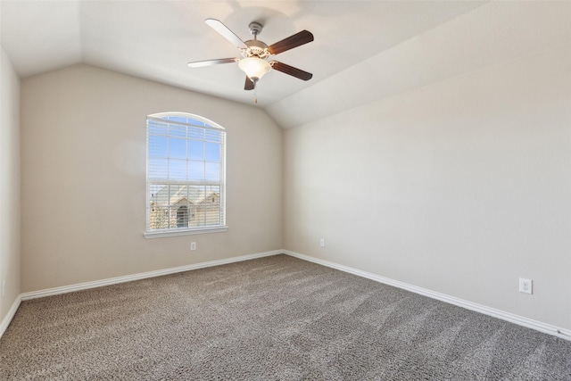 empty room with lofted ceiling, ceiling fan, and carpet