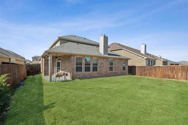 rear view of property featuring a yard