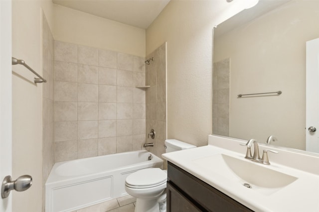 full bathroom with tiled shower / bath, vanity, and toilet