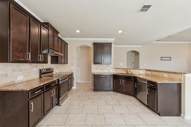 kitchen with appliances with stainless steel finishes, kitchen peninsula, sink, light stone counters, and dark brown cabinetry