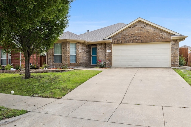 ranch-style house featuring a garage and a front lawn