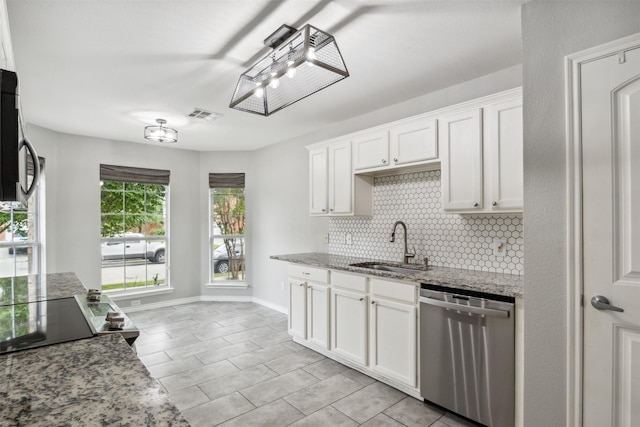 kitchen featuring sink, white cabinetry, dishwasher, light stone countertops, and decorative backsplash