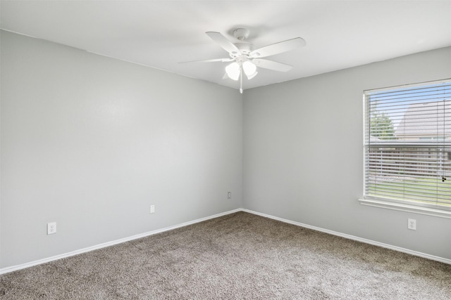 carpeted spare room with ceiling fan