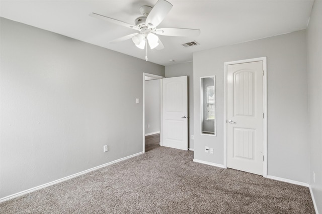 unfurnished bedroom featuring ceiling fan and carpet floors