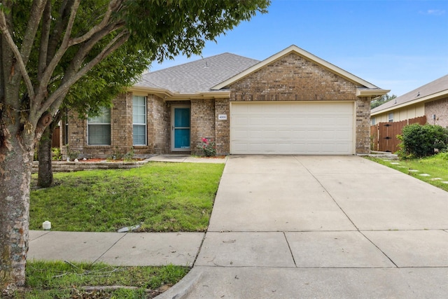 ranch-style house with a garage and a front lawn