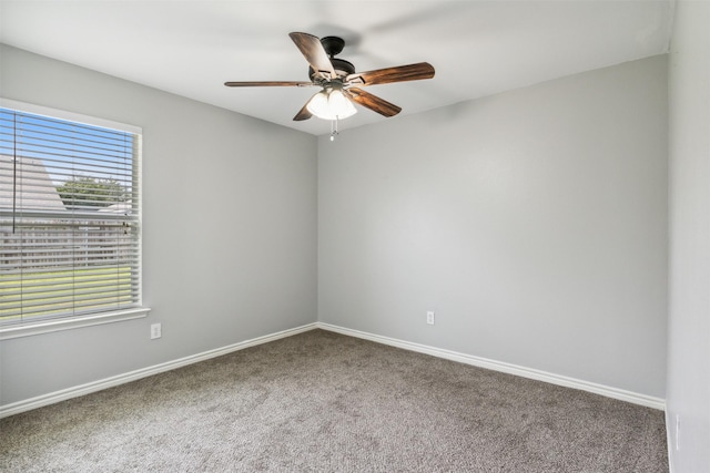 unfurnished room with ceiling fan and carpet