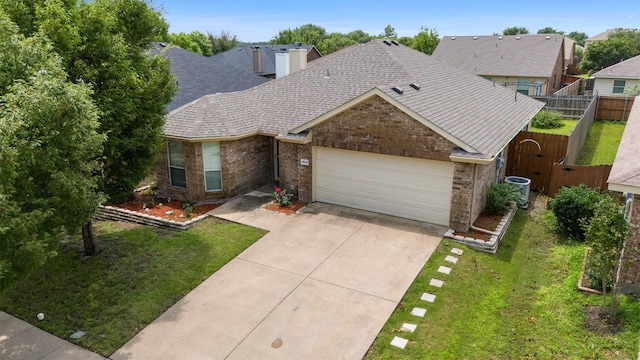 ranch-style house with cooling unit, a garage, and a front yard