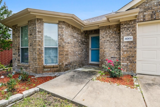 doorway to property with a garage