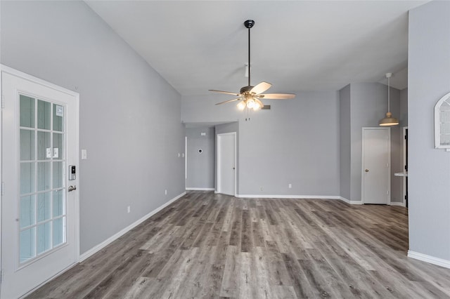 unfurnished living room with lofted ceiling, hardwood / wood-style flooring, and ceiling fan