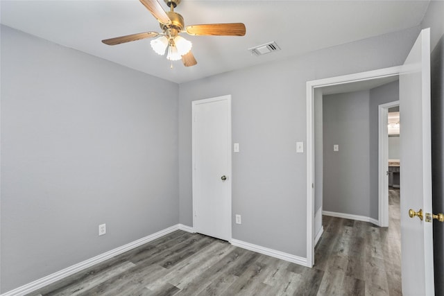 unfurnished bedroom featuring wood-type flooring and ceiling fan