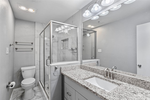 bathroom featuring vanity, toilet, and walk in shower