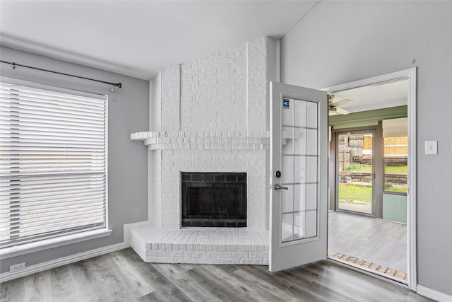 unfurnished living room with hardwood / wood-style flooring and a fireplace