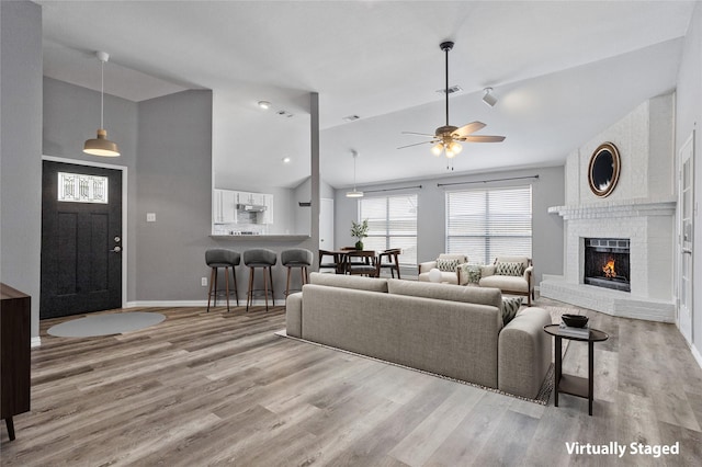 6329 Peggy Dr, Fort Worth, TX 76133 - living room featuring visible vents, baseboards, a fireplace, ceiling fan, and wood finished floors