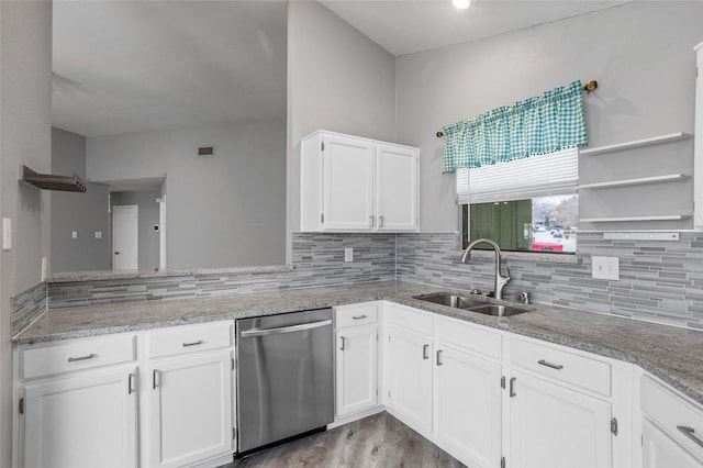 kitchen with sink, dishwasher, white cabinets, decorative backsplash, and light wood-type flooring