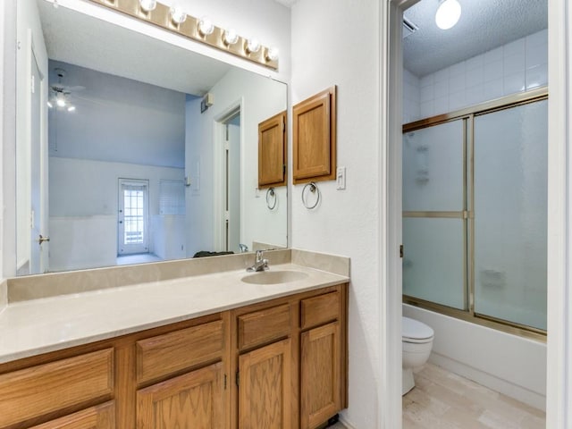 full bathroom with hardwood / wood-style floors, enclosed tub / shower combo, vanity, ceiling fan, and toilet