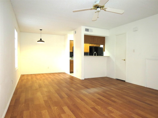 unfurnished room featuring ceiling fan and hardwood / wood-style floors