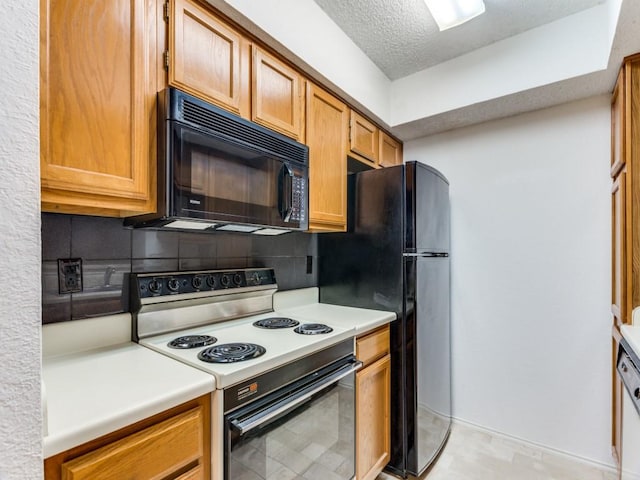 kitchen with decorative backsplash, black appliances, and a textured ceiling