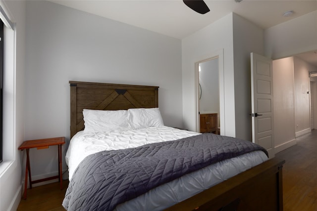 bedroom with dark wood-type flooring, connected bathroom, and ceiling fan