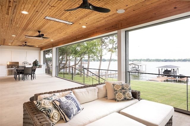 sunroom with a water view and wood ceiling