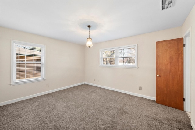 carpeted empty room featuring plenty of natural light