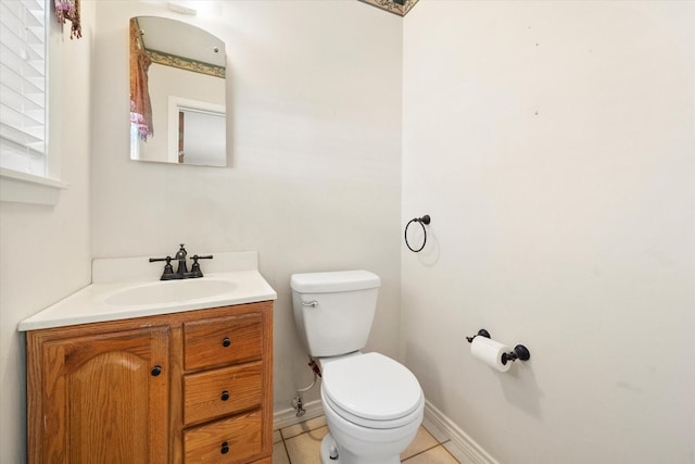 bathroom with vanity, tile patterned flooring, and toilet