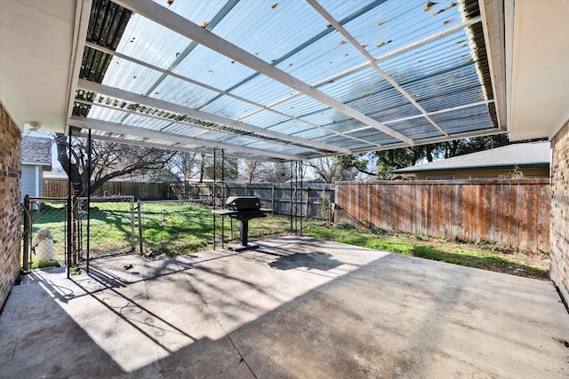 view of patio with area for grilling and a pergola