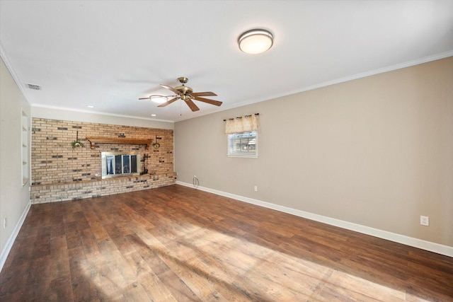 unfurnished living room featuring brick wall, hardwood / wood-style floors, ceiling fan, crown molding, and a brick fireplace