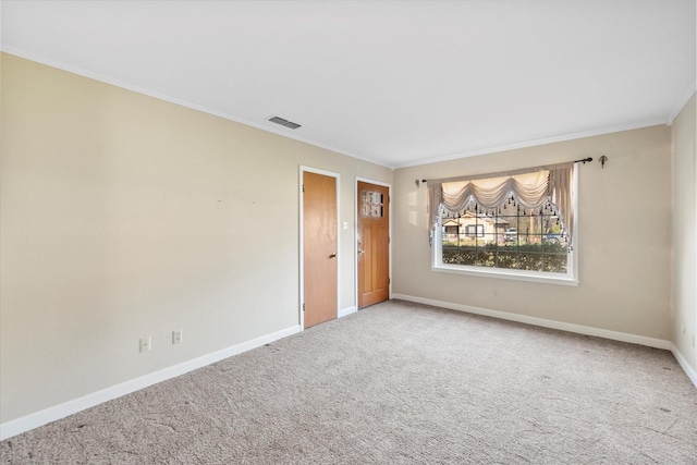 spare room featuring crown molding and carpet flooring