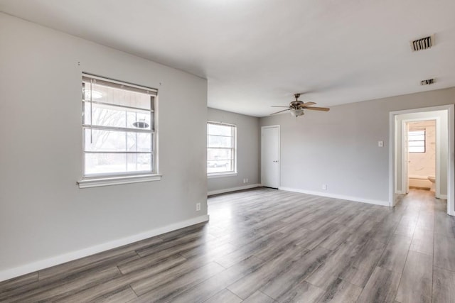 unfurnished room featuring ceiling fan and hardwood / wood-style floors