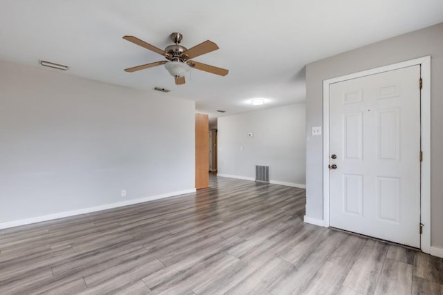 empty room featuring ceiling fan and light wood-type flooring