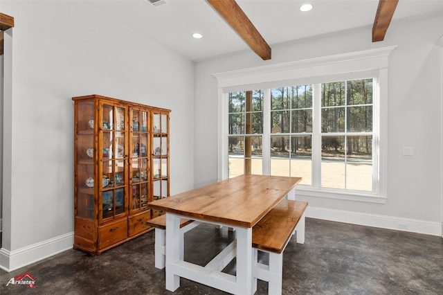 dining space featuring beamed ceiling and a healthy amount of sunlight