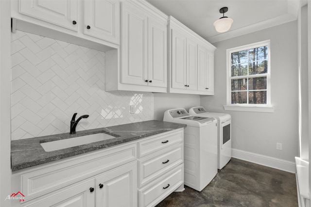 washroom featuring sink, cabinets, and washing machine and clothes dryer