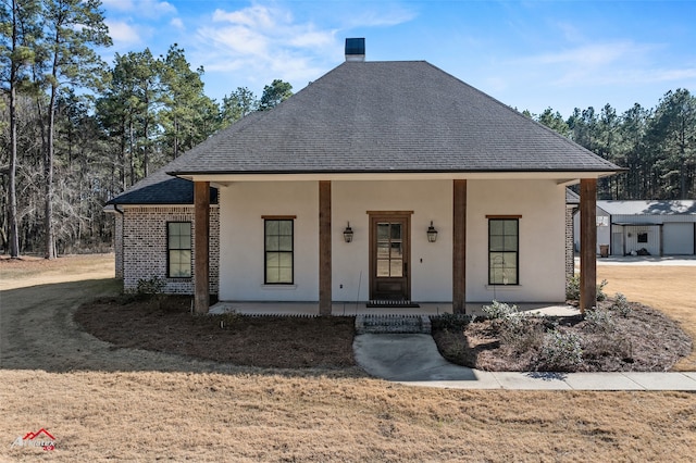 view of front of property with a front yard and a porch