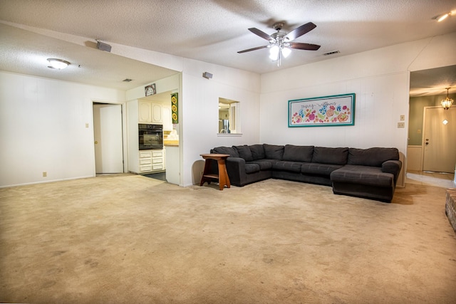 1225 Crestwood Dr, Cleburne, TX 76033 - living area featuring a textured ceiling, ceiling fan, light colored carpet, and visible vents