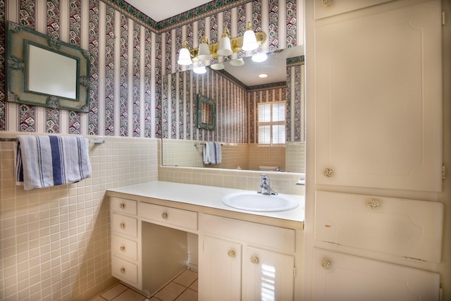 1225 Crestwood Dr, Cleburne, TX 76033 - bathroom featuring wallpapered walls, vanity, a wainscoted wall, and tile walls