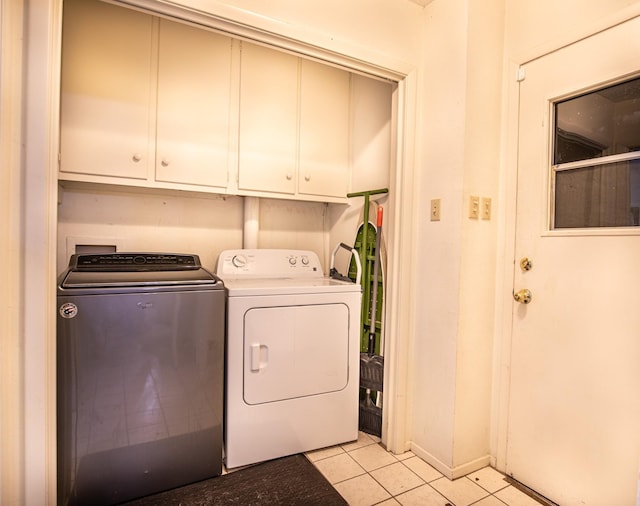 1225 Crestwood Dr, Cleburne, TX 76033 - laundry area featuring washer and dryer, light tile patterned flooring, and cabinet space