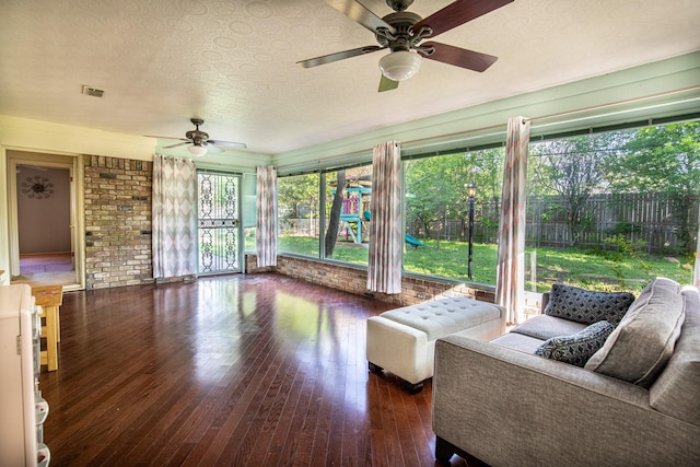 1225 Crestwood Dr, Cleburne, TX 76033 - sunroom with brick wall, wood-type flooring, visible vents, and a textured ceiling