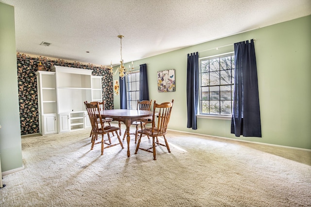1225 Crestwood Dr, Cleburne, TX 76033 - carpeted dining area featuring a textured ceiling, an inviting chandelier, baseboards, and visible vents