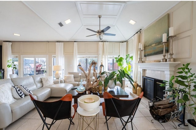 living room featuring vaulted ceiling, light tile patterned floors, and ceiling fan