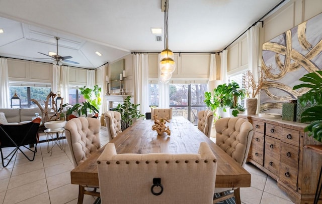 dining space featuring lofted ceiling, a ceiling fan, and light tile patterned flooring