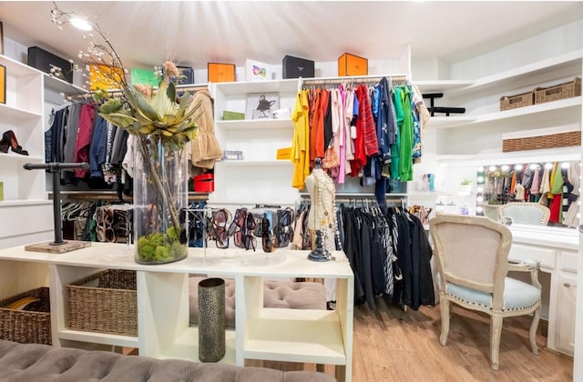 walk in closet with light wood-style flooring