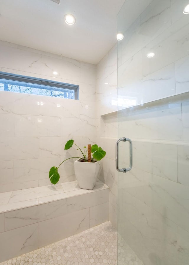 bathroom with a shower with shower door