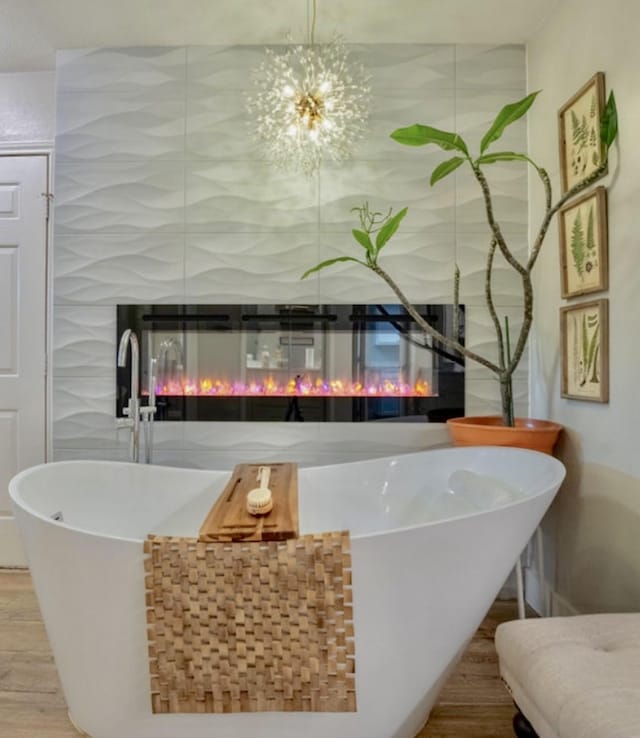 bar featuring a glass covered fireplace and wood finished floors