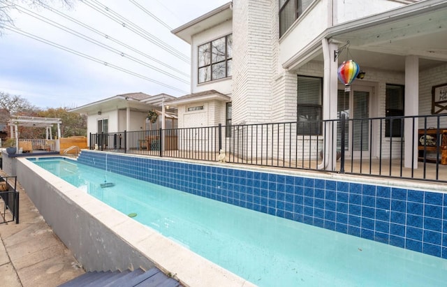 view of pool featuring a fenced in pool, fence, and a pergola